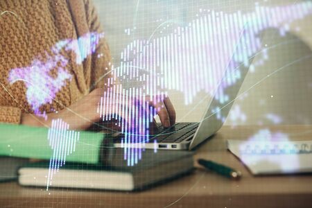 Double exposure of woman hands typing on computer and business theme hologram drawing. Success concept.の写真素材
