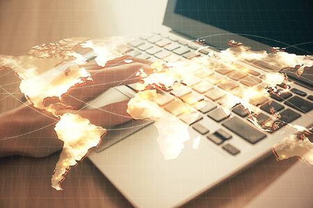 Double exposure of woman hands typing on computer and business theme hologram drawing. Success concept.の写真素材