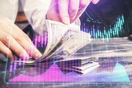 Multi exposure of forex graph drawing hologram and USA dollars bills and man hands. Technical Analysis concept.の写真素材