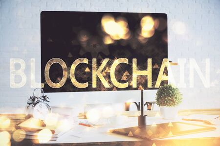 Multi exposure of blockchain and crypto economy theme hologram and table with computer background. Concept of bitcoin cryptocurrency.の写真素材