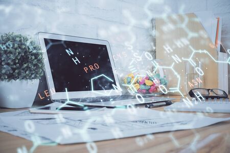 Desktop computer background and formula hologram writing. Double exposure. Education concept.の写真素材