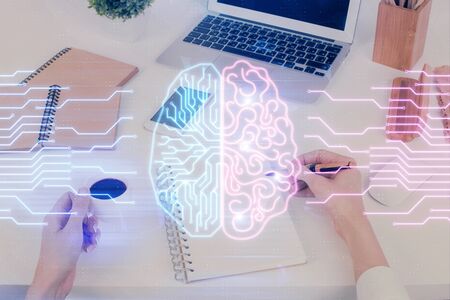 Double exposure of womans writing hand on background with brain hud. Concept of learning.の写真素材