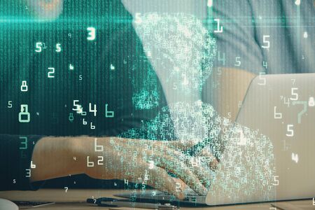 Multi exposure of data internet theme hologram with man working on computer on background. Concept...