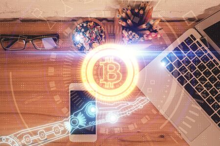 Double exposure of blockchain theme hologram over table with phone. Top view. Crypto technology concept.の写真素材