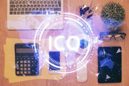 Double exposure of blockchain theme hologram over table with phone. Top view. Crypto technology concept.の写真素材