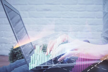 Multi exposure of woman hands typing on computer and forex chart hologram drawing. Stock market analysis concept.の写真素材