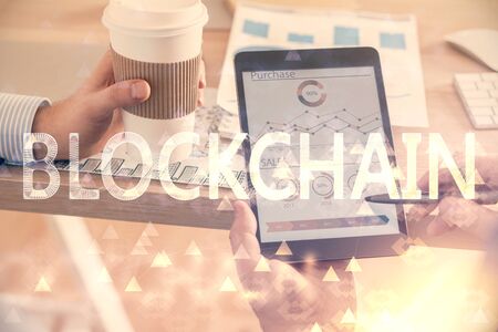 Double exposure of mans hands holding and using a phone and crypto currency blockchain theme drawing.の写真素材