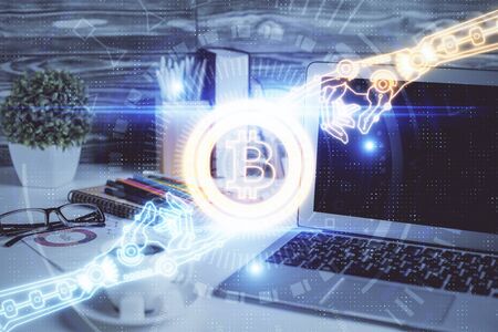 Double exposure of blockchain and crypto economy theme hologram and table with computer background....