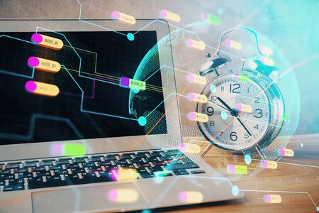 Double exposure of desktop with computer and world map hologram. International data network concept.の写真素材
