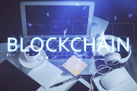 Multi exposure of blockchain and crypto economy theme hologram and table with computer background. Concept of bitcoin cryptocurrency.の写真素材