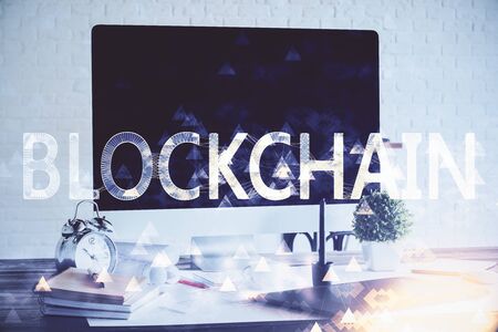 Multi exposure of blockchain and crypto economy theme hologram and table with computer background. Concept of bitcoin cryptocurrency.の写真素材