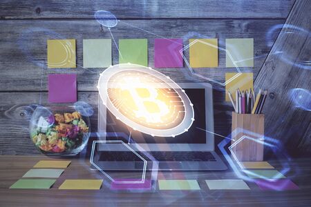 Double exposure of blockchain and crypto economy theme hologram and table with computer background. Concept of bitcoin cryptocurrency.の写真素材