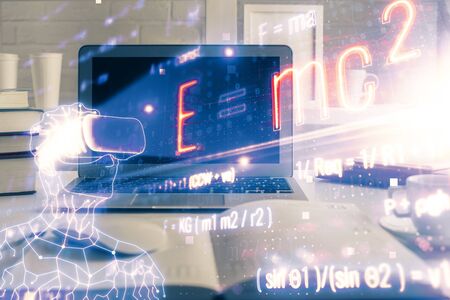 Desktop computer background and formula hologram writing. Double exposure. Education concept.の写真素材