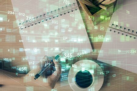 Multi exposure of womans writing hand on background with data technology hud. Concept of innovation.の写真素材