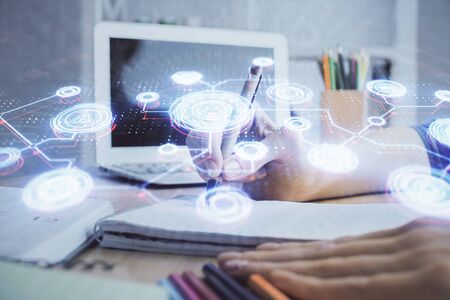 Social network theme hologram over woman's hands writing background. Concept of international people connect. Double exposureの写真素材