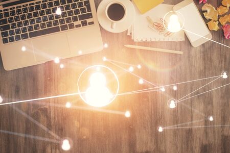 Social network hologram drawings over computer on the desktop background. Top view. Double exposure.の写真素材