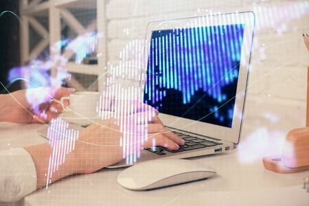 Double exposure of woman hands typing on computer and business theme hologram drawing. Success concept.の写真素材