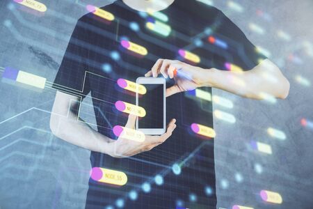 Double exposure of mans hand holding and using a digital device and data theme hologram drawing. Technology concept.の写真素材