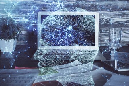 Double exposure of table with computer and brain hologram. Data innovation concept.の写真素材