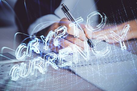 Cryptocurrency hologram over womans hands writing background. Concept of blockchain. Multi exposureの写真素材