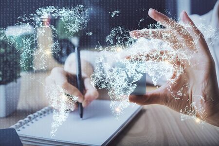 Social network theme hologram over womans hands writing background. Concept of international people connect. Double exposureの写真素材