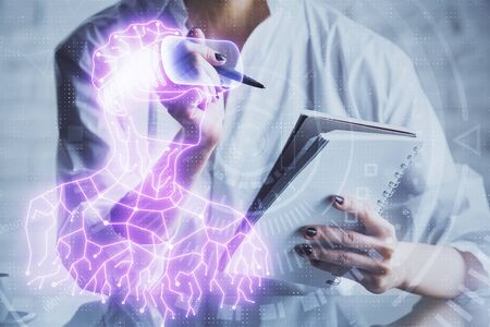 AR hologram over womans hands taking notes background. Concept of augmented reality. Multi exposureの写真素材
