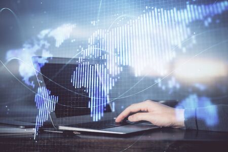 Multi exposure of businessman working on laptop on background. International business hologram in front. Concept of success.の写真素材