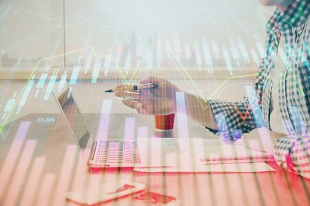Multi exposure of stock market chart with man working on computer on background. Concept of financial analysis.の写真素材