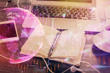 Multi exposure of financial graph drawings and desk with open notebook background. Concept of forexの写真素材