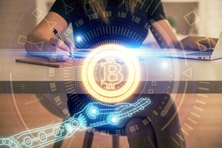 Double exposure of woman hands typing on computer and crypto market theme hologram drawing. Blockchain concept.の写真素材