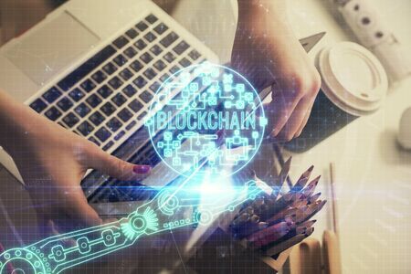 Double exposure of woman hands typing on computer and crypto market theme hologram drawing. Blockchain concept.の写真素材
