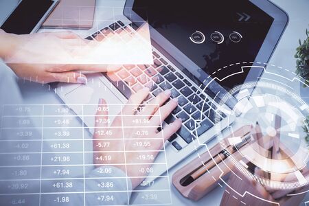 Multi exposure of woman hands typing on computer and forex chart hologram drawing. Stock market analysis concept.の写真素材