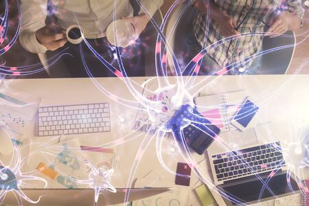 Double exposure of man and woman working together and neuron hologram drawing. Computer background. Top View. Education concept.の写真素材