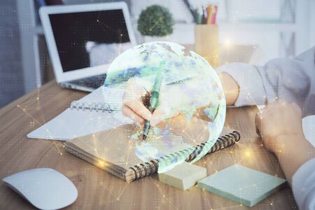 Social network theme hologram over womans hands writing background. Concept of international people connect. Double exposureの写真素材