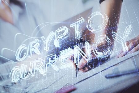 Cryptocurrency hologram over woman's hands writing background. Concept of blockchain. Multi exposureの写真素材