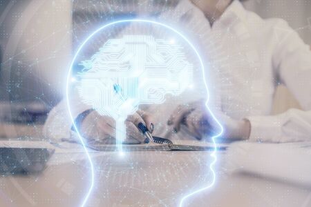 Multi exposure of writing hand on background with brain hologram. Concept of self learning.