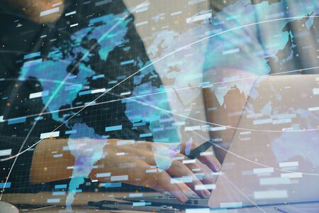 Multi exposure of data internet theme hologram with man working on computer on background. Concept of innovation.の写真素材