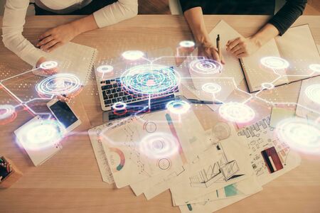Double exposure of woman hands working on computer and social network theme hologram drawing. Top View. People connection concept.の写真素材