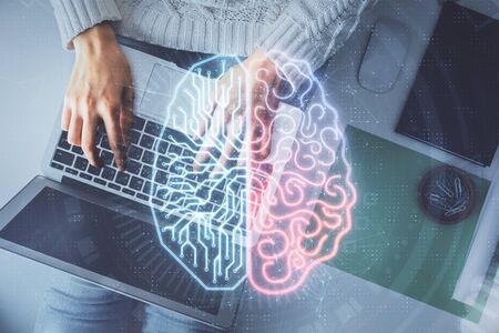 Double exposure of woman working on computer andhuman brain hologram drawing. Top View. Ai concept.の写真素材