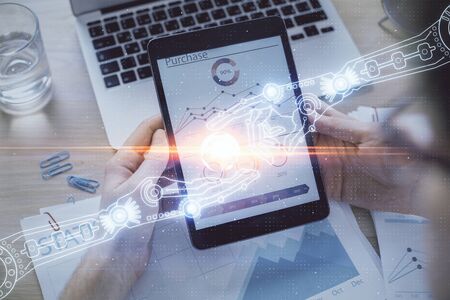 Double exposure of mans hand holding and using a digital device and data theme hologram drawing....