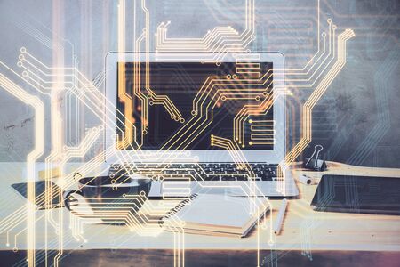 Computer on desktop in office with technology theme hologram. Multi exposure. Tech concept.の写真素材