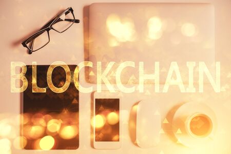 Double exposure of blockchain theme hologram over table with phone. Top view. Crypto technology concept.の写真素材