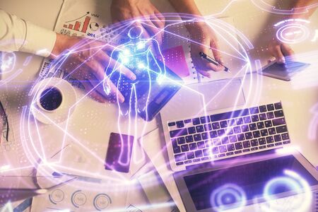 Double exposure of man and woman working together and education theme hologram drawing. Computer...