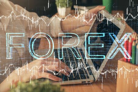 Double exposure of woman hands typing on computer and forex chart hologram drawing. Stock market invest concept.の写真素材