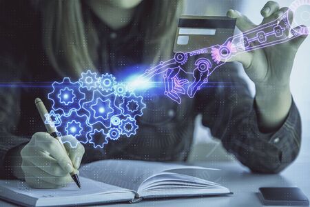 Double exposure of woman on-line shopping holding a credit card and data theme hologram drawing. E-commerce concept.の写真素材