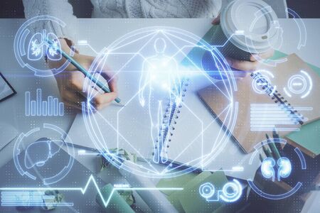 Education theme hologram over womans hands writing background. Concept of study. Double exposureの写真素材