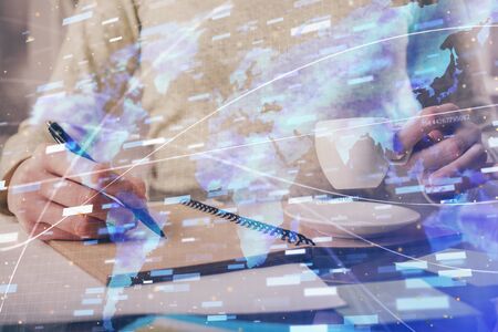 Double exposure of writing hands on background with data solution hologram on front. Technology concept. Side view.の写真素材