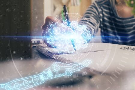Double exposure of hands making notes with digital coding icons. Computer learning concept.