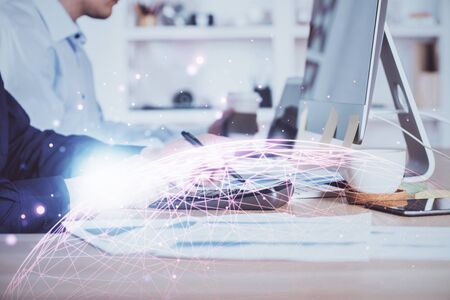 Media network theme hologram with man working on computer on background. Concept of internet communication. Double exposure.の写真素材