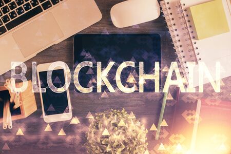 Double exposure of blockchain theme hologram over table with phone. Top view. Crypto technology concept.の写真素材
